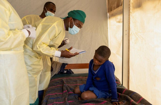 FILE PHOTO: Dr. Tresor Wakilongo, verifies the evolution of skin lesions on the ear of Innocent, suffering from Mpox - an infectious disease caused by the monkeypox virus that sparks off a painful rash, enlarged lymph nodes and fever; at the treatment centre in Munigi, following Mpox cases in Nyiragongo territory near Goma, North Kivu province, Democratic Republic of the Congo July 19, 2024. REUTERS/Arlette Bashizi/File Photo